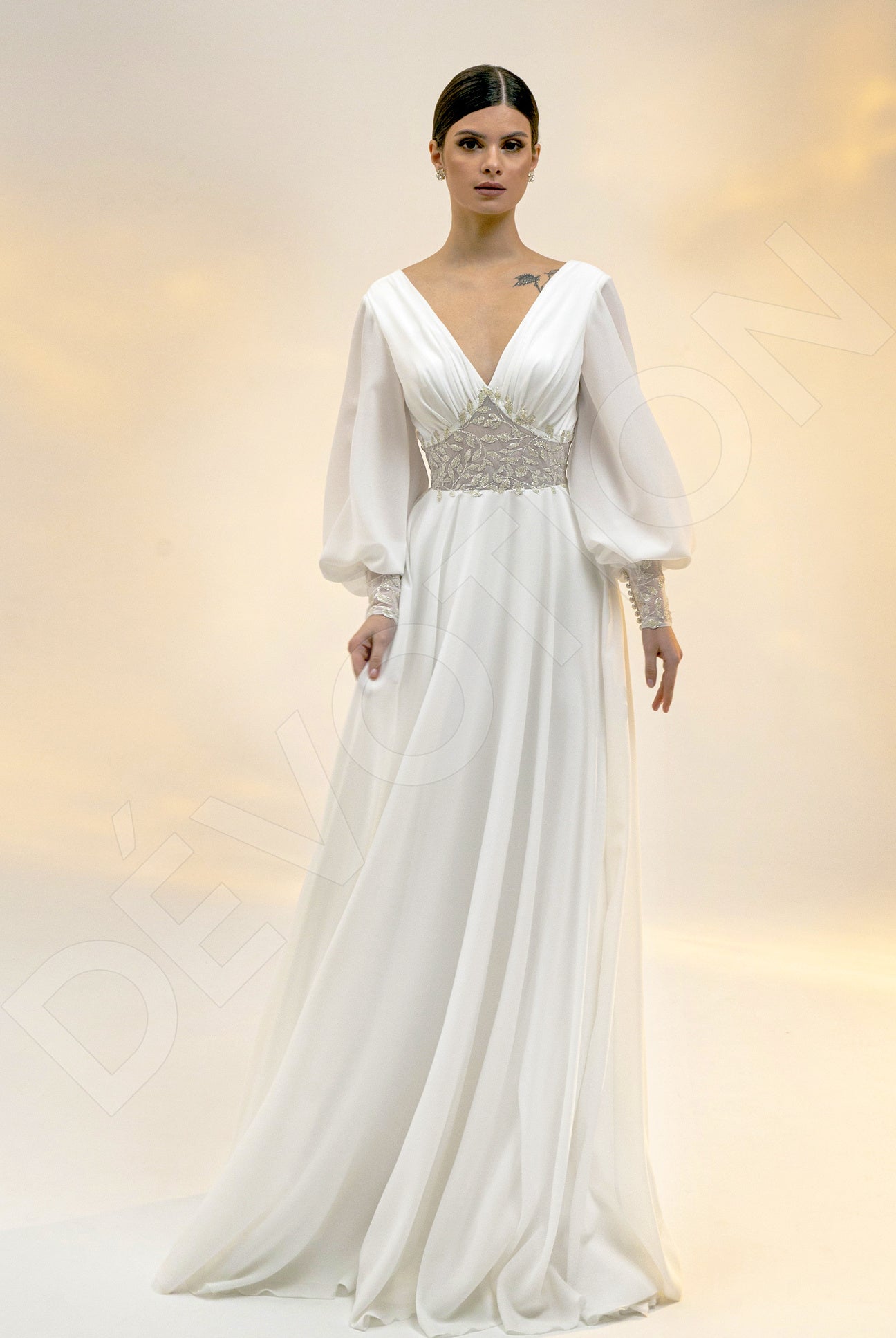 A bride in the Afinea A-line V-neck Light Ivory Wedding dress, perfect for a romantic sunset stroll.