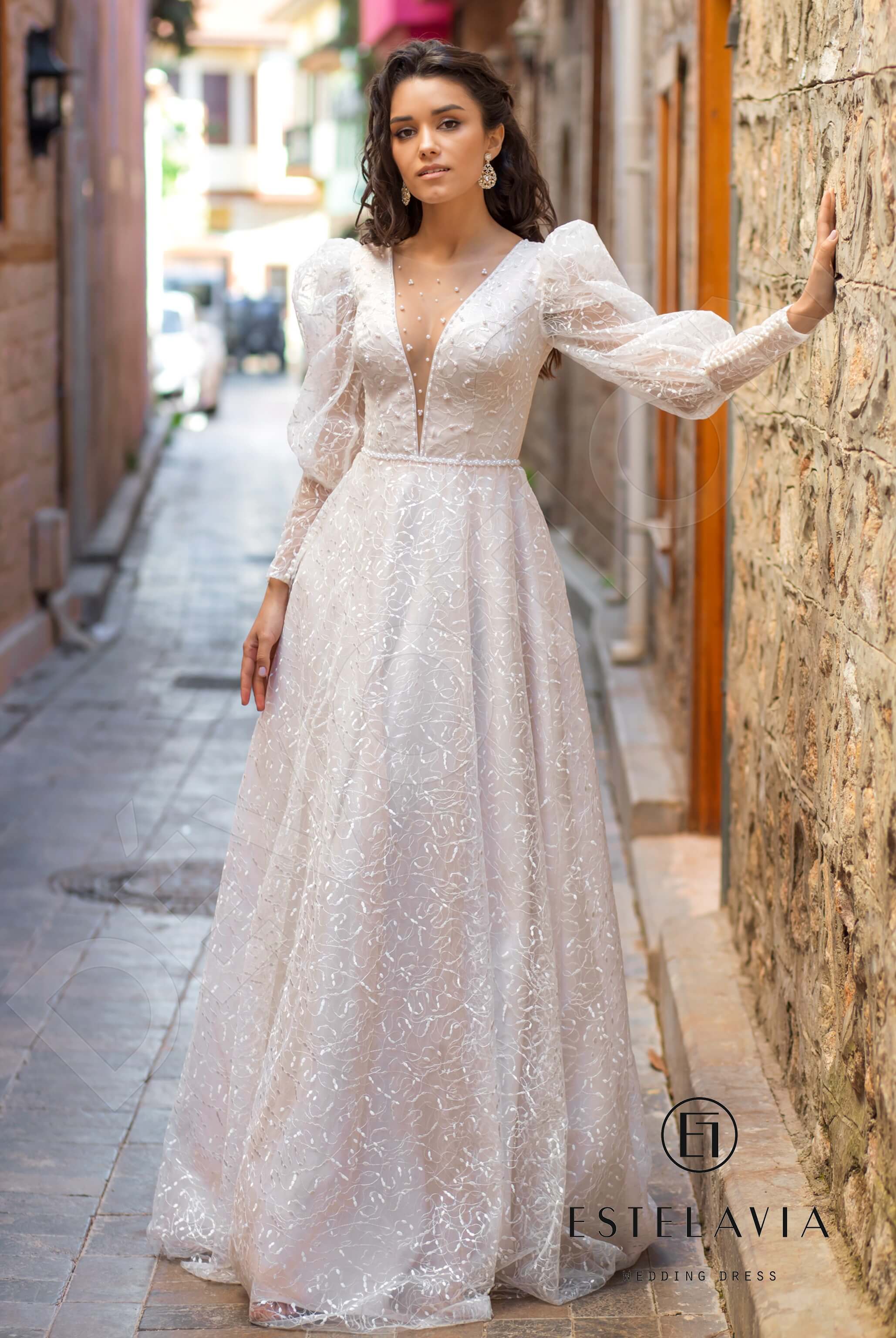 The timeless elegance of the Alfre A-line Illusion Milk Cappuccino Wedding dress, inspiring confidence for your special address.