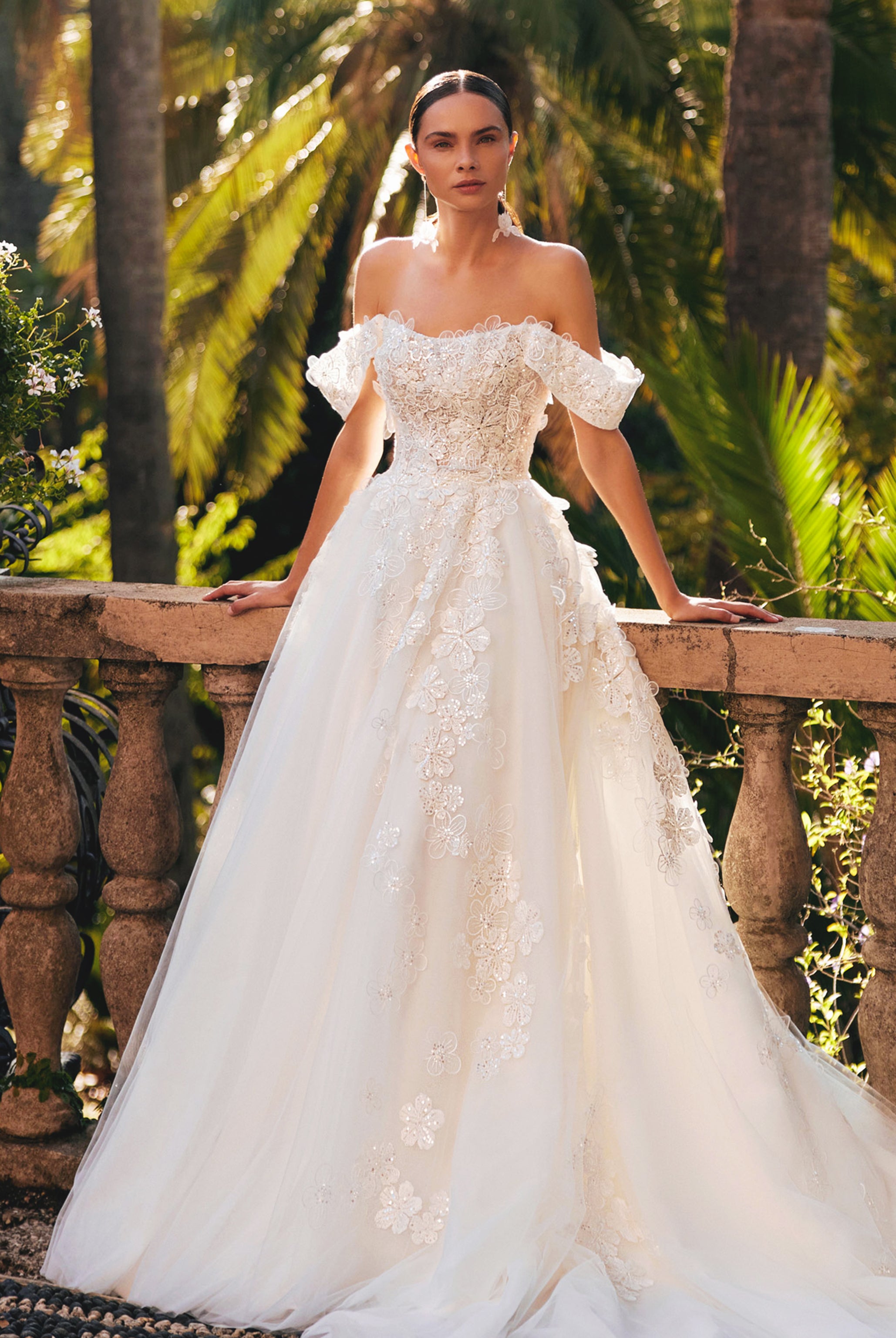 A bride in a sophisticated A-line straight-across gown with a detachable train, ready to transition from ceremony to celebration.