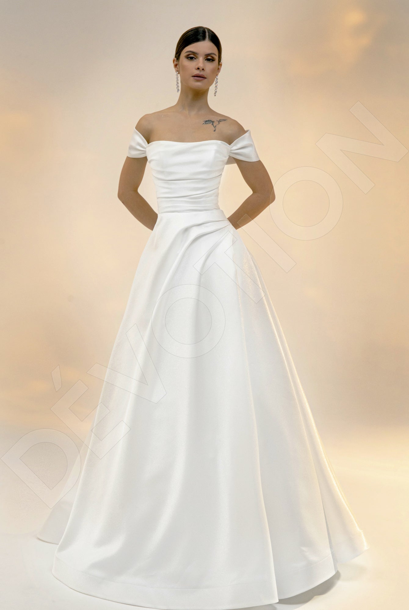 An elegant bride in an off-shoulder A-line light ivory wedding dress, embodying grace and sophistication