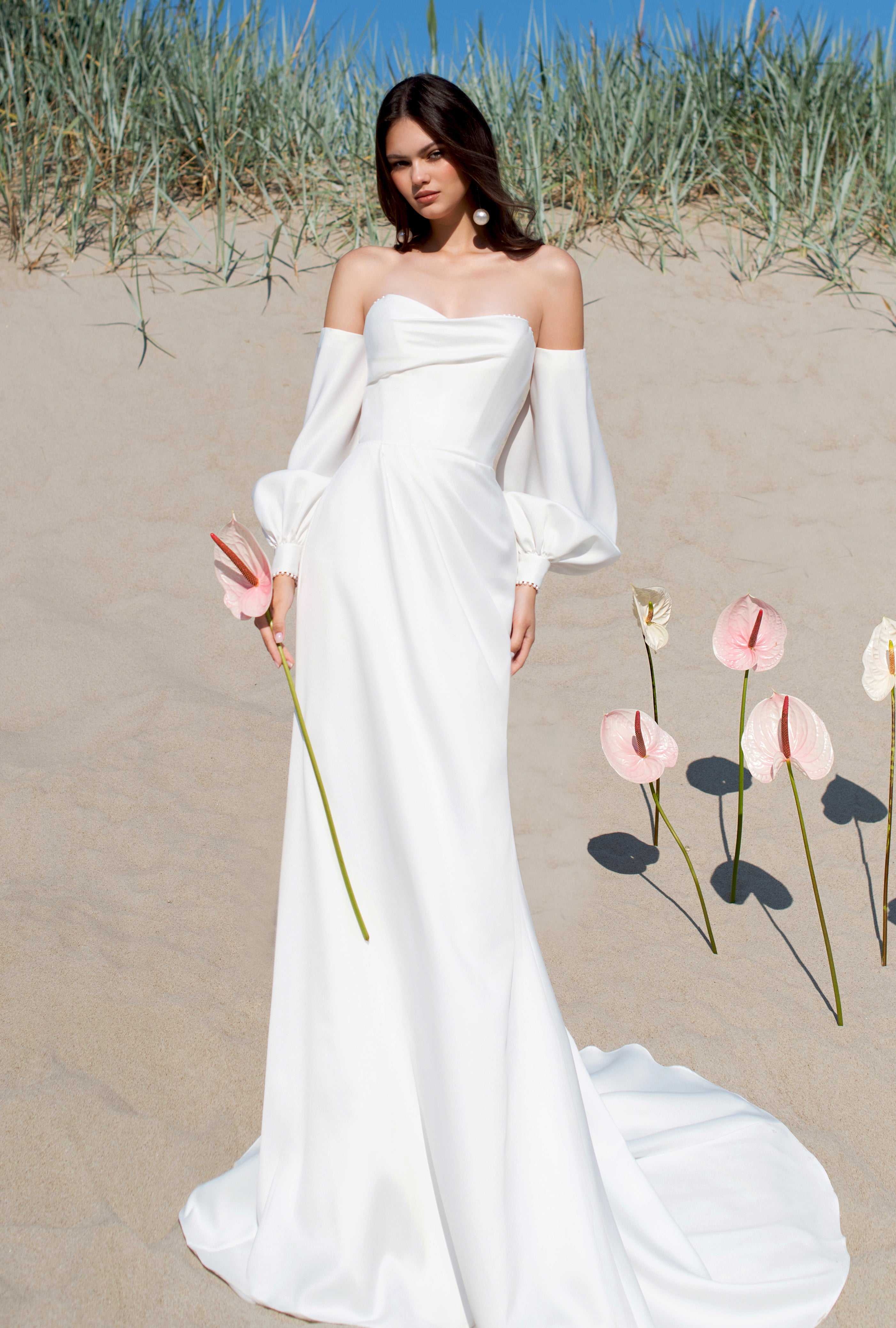 A bride looking stunning in a two-in-one sweetheart off-white wedding dress, ideal for a versatile wedding day look.
