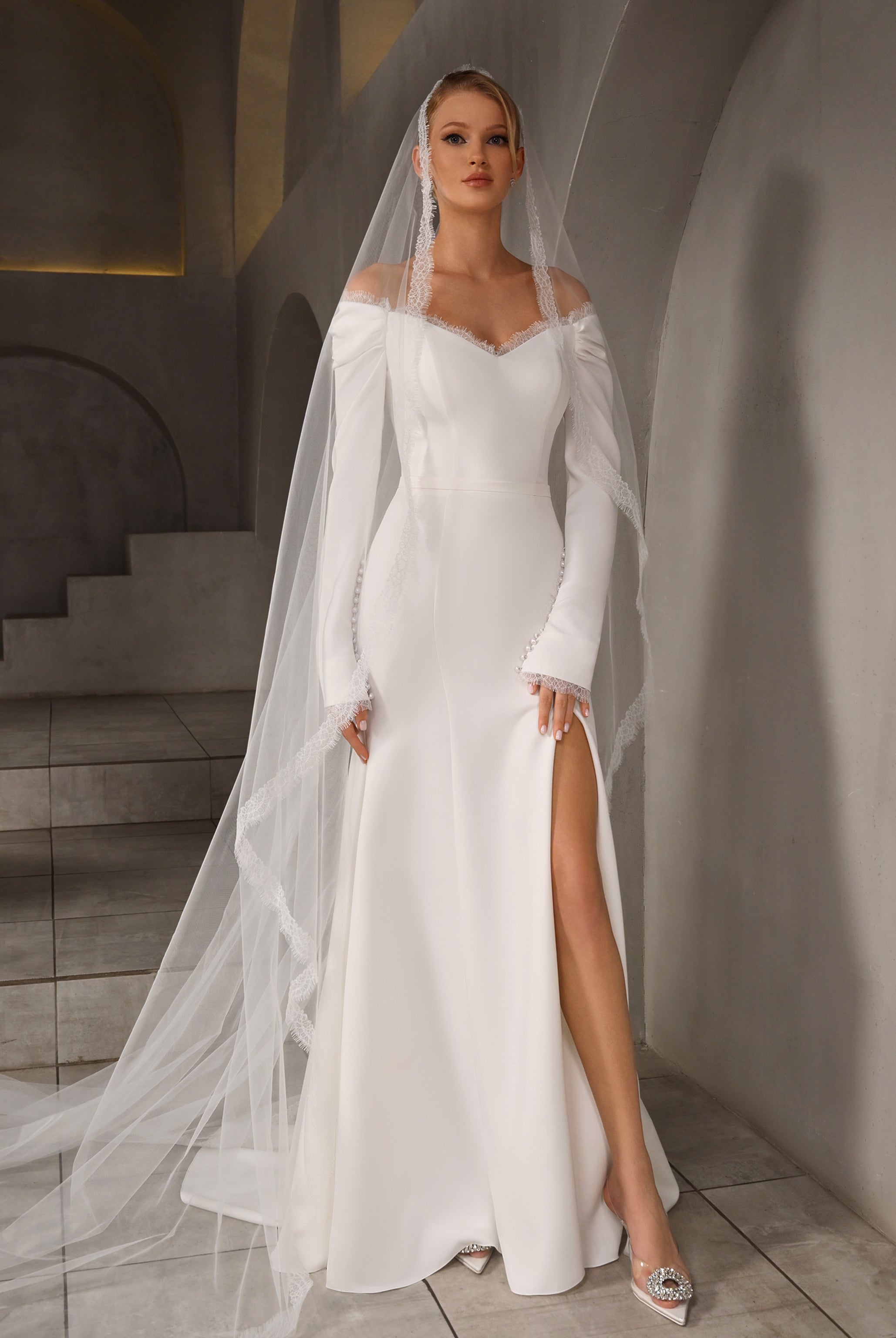 A bride radiating elegance in the Stelle Trumpet/Mermaid Off-shoulder/Drop shoulder Milk Wedding dress, showcasing its flattering silhouette and luxurious fabric.